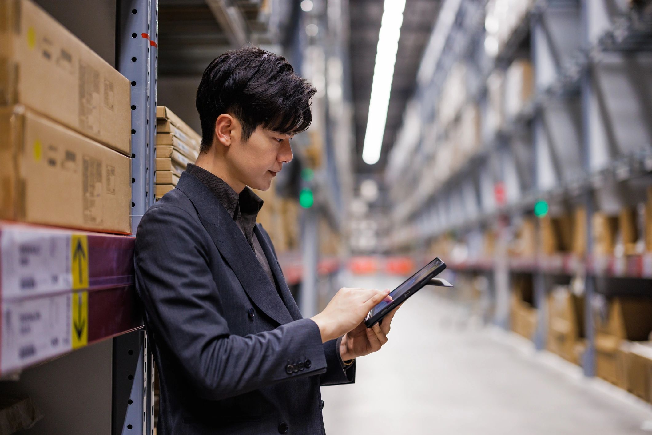 Professional holding a tablet in a work environment