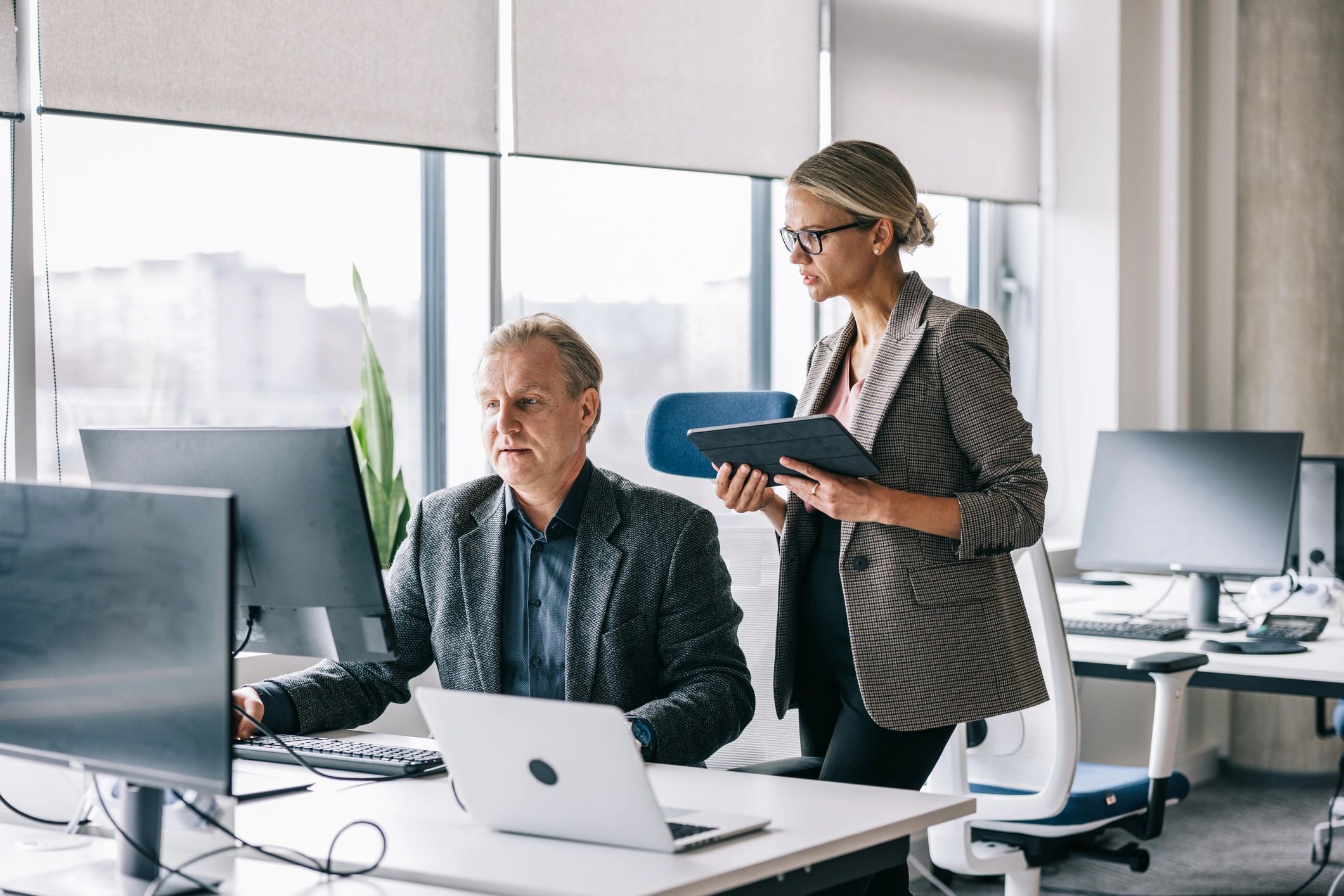 Two colleagues working together at a desk