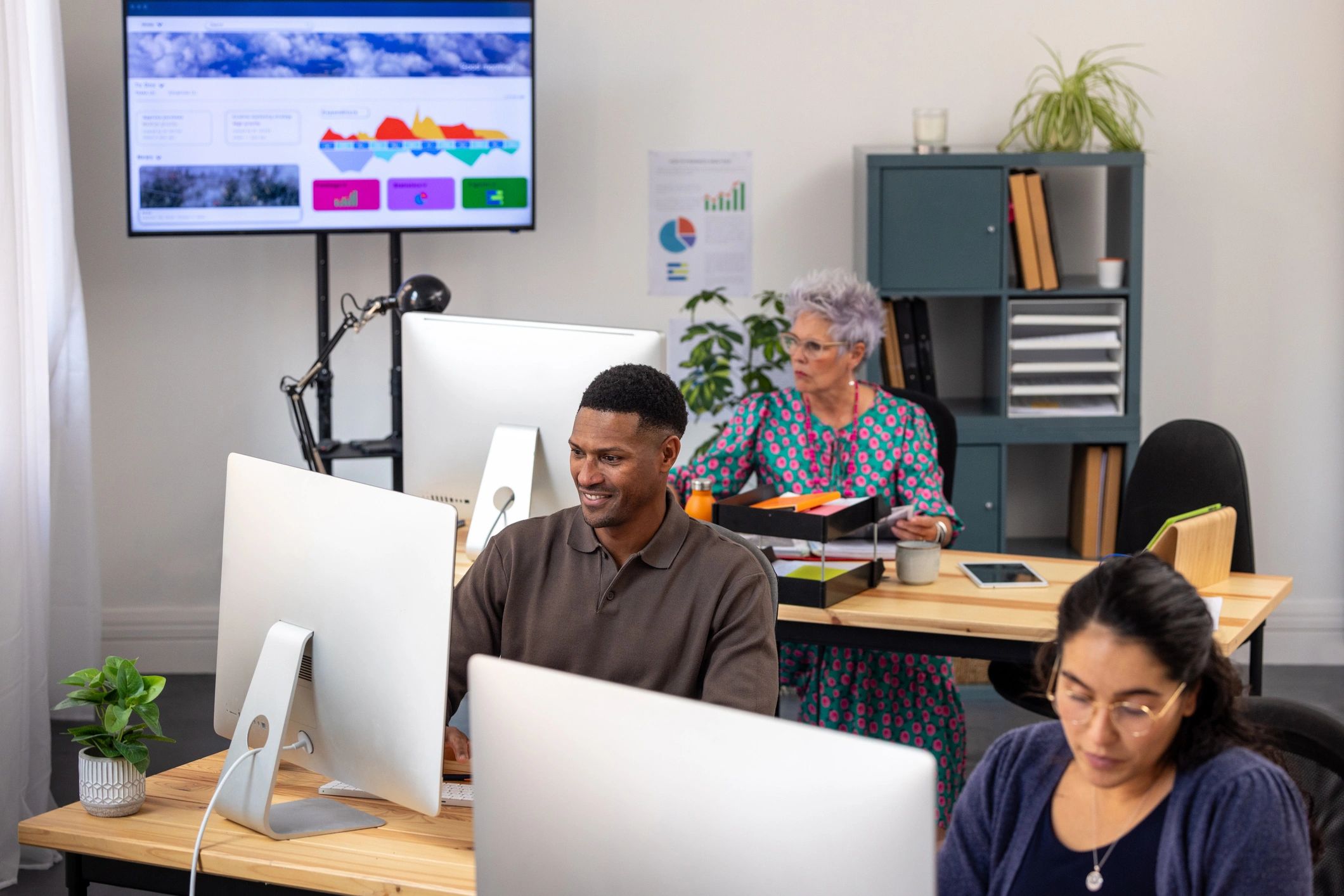 IT support team monitoring systems in a modern operations workspace