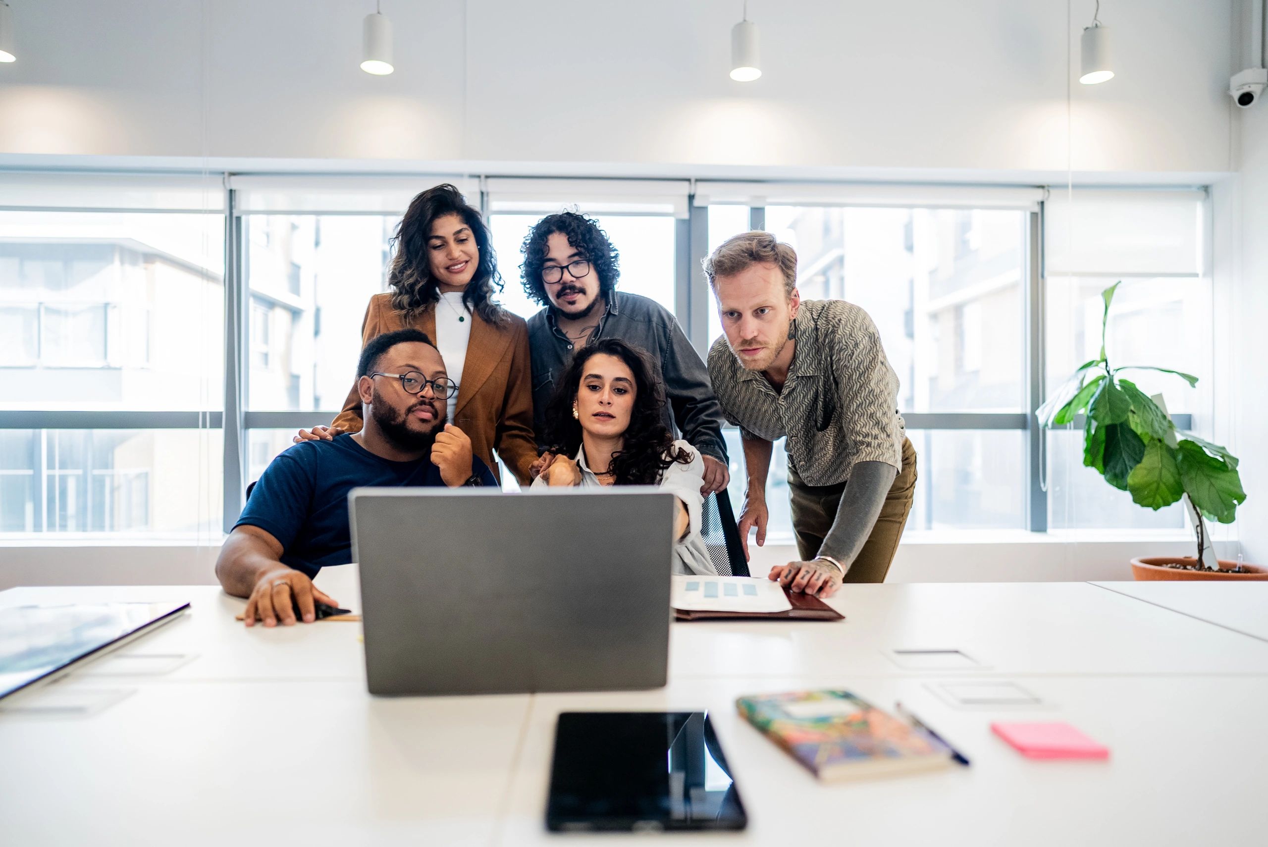 Coworkers discussing work at a laptop