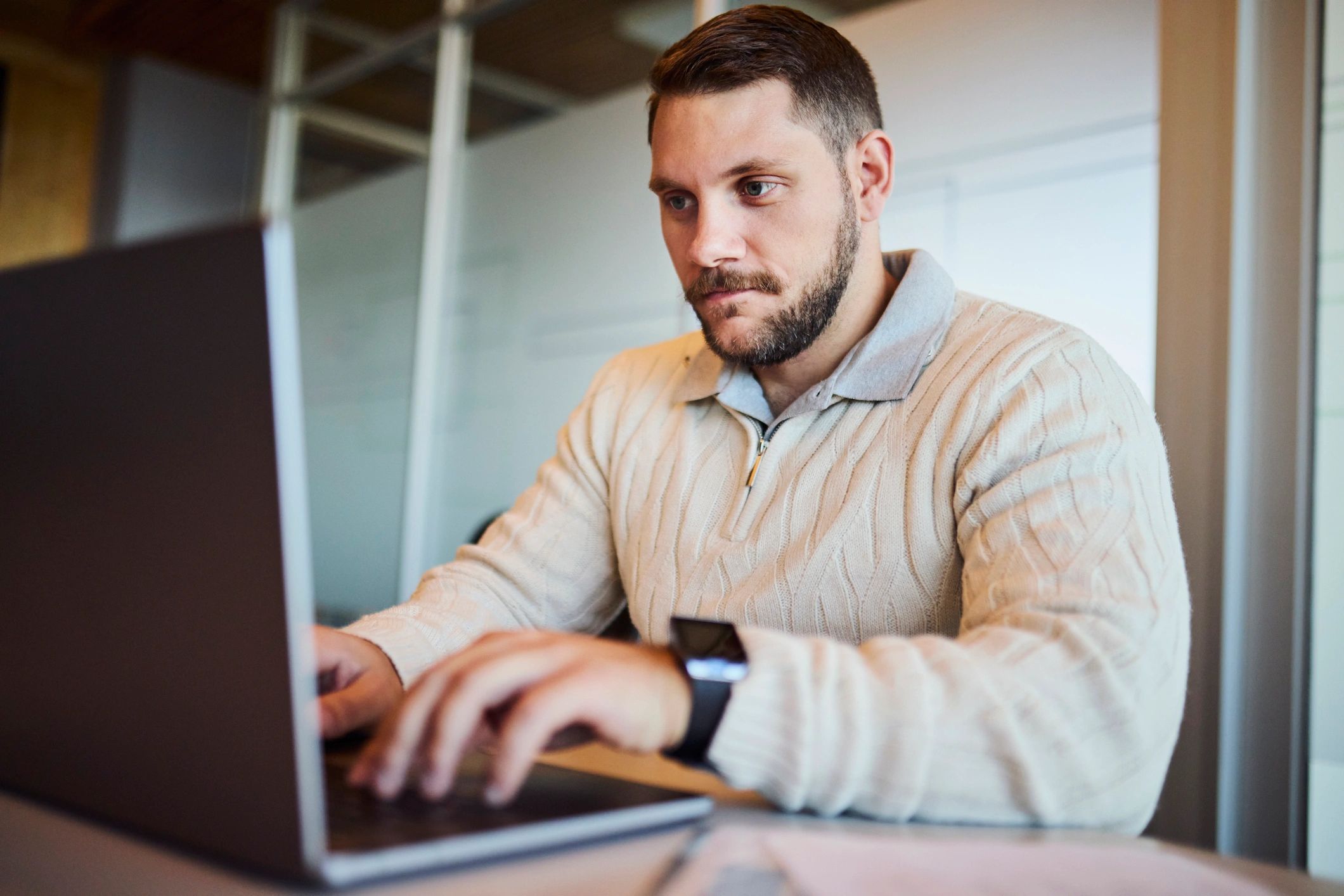 Security professional working on a laptop at a desk
