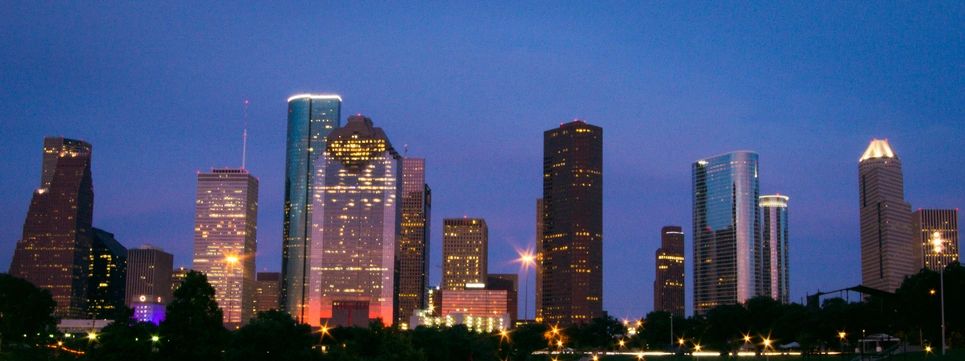 Houston skyline at dusk representing local service and presence