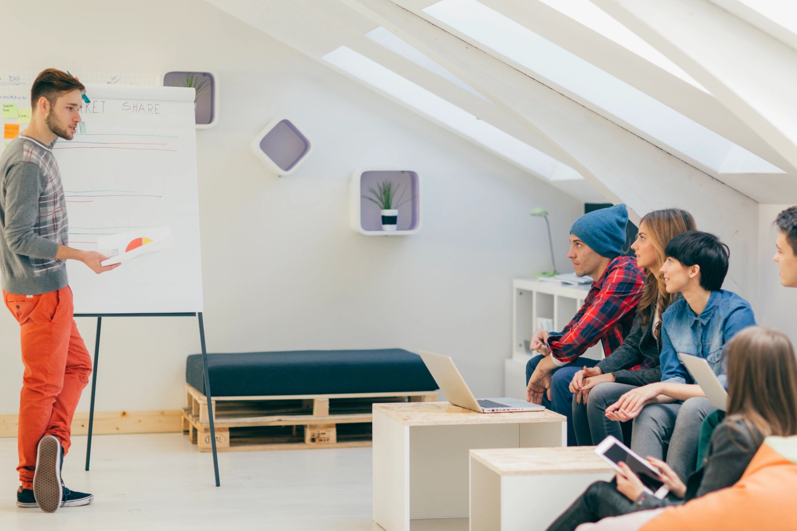 Presenter briefing colleagues in a modern office