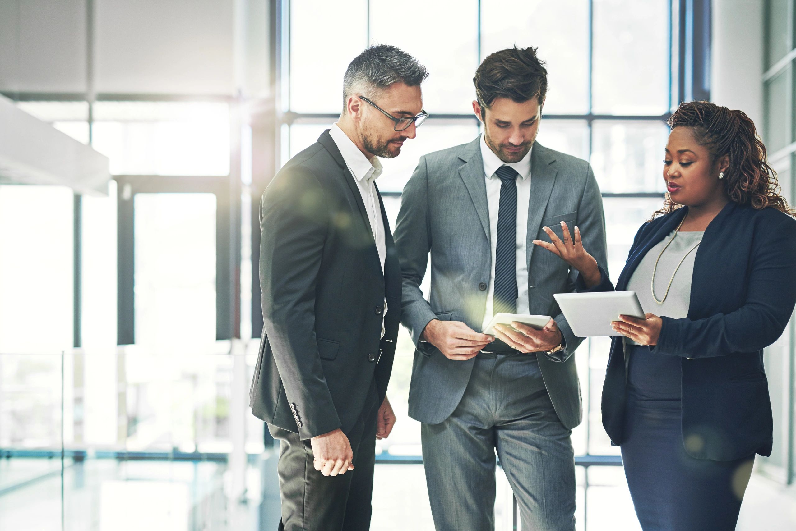 IT leaders collaborating on a technology strategy plan in a modern office